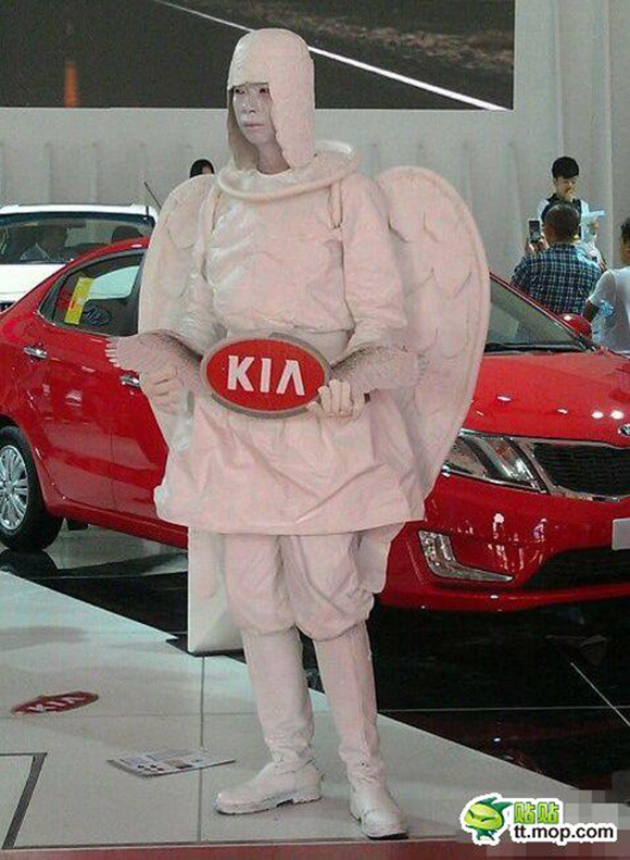 Sad angel looking for career change sells Kias at motor show