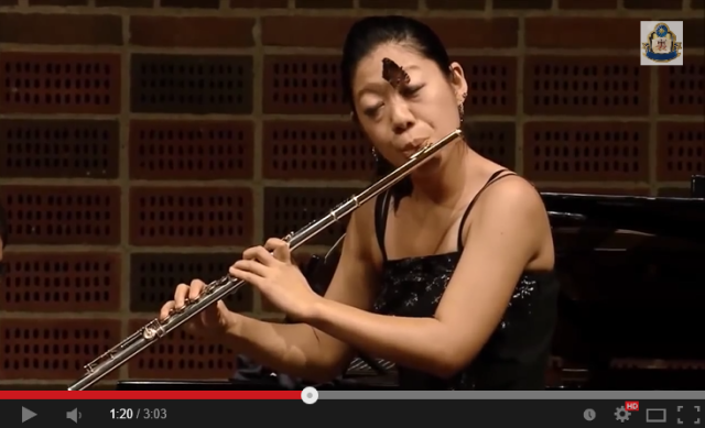Japanese flutist keeps her cool, plays beautifully even with a butterfly crawling across her face