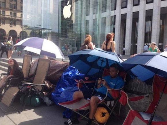 people-lounged-with-umbrellas-outside-the-flagship-fifth-ave-store-in-new-york-city