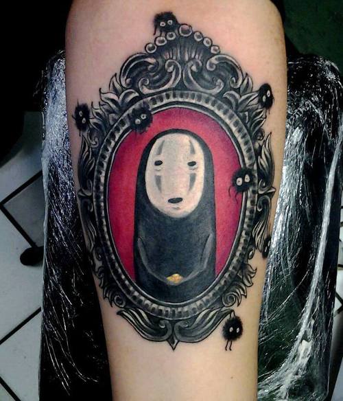 Spirited Away tattoo on the inner arm.