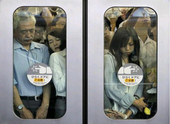 Filled to bursting point? Rush-hour crush on Tokyo subway leaves train with broken window