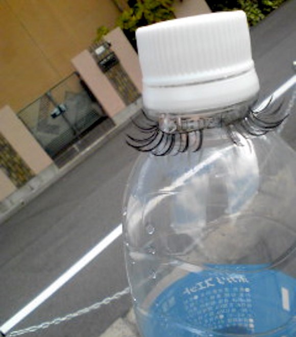 fun with false fake eyelashes, on plastic water bottle