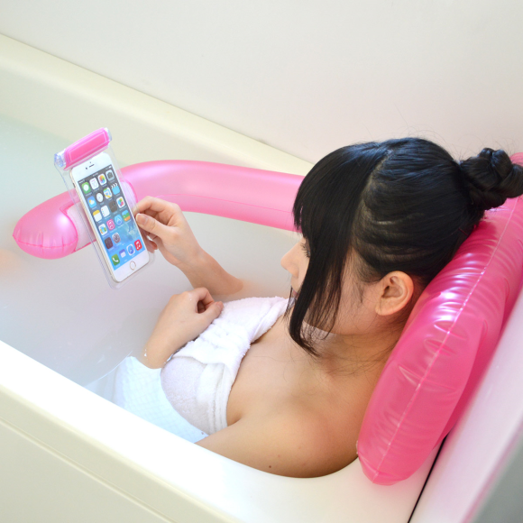 Handy bath pillow doubles as a smartphone holder, might also be giving you  a hug