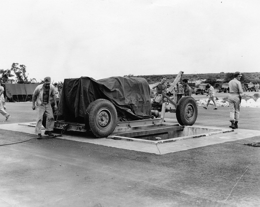 at-the-airfield-fat-man-is-lined-up-over-a-pit-specifically-constructed-for-it-from-which-it-is-then-loaded-into-the-plane-that-dropped-it-over-nagasaki-on-august-9-1945 (1)