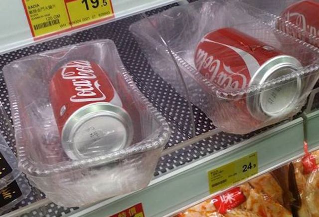 Cans of Coca Cola wrapped and sealed in plastic containers leave us wondering “WHY?!”
