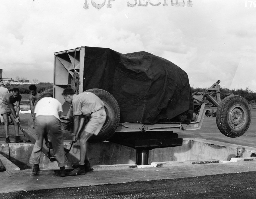the-bomb-and-its-trailer-are-lowered-down-into-the-pit-using-a-hydraulic-lift
