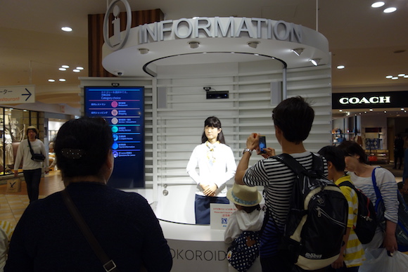 Interactive android helps visitors in three languages at information desk in Japanese mall