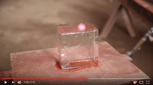 Watch a super hot ball of iron get dropped onto an ice cube, because why not?