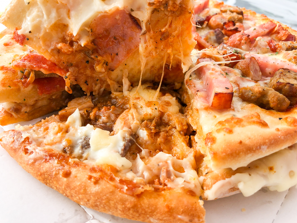 We try the giant Meat Mountain pizza sandwich from Aoki’s Japan