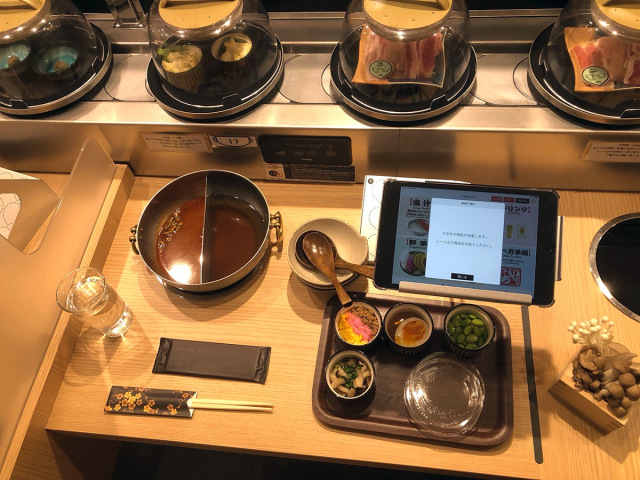Japanese restaurant combines solo shabu shabu dining with the fun of a sushi train