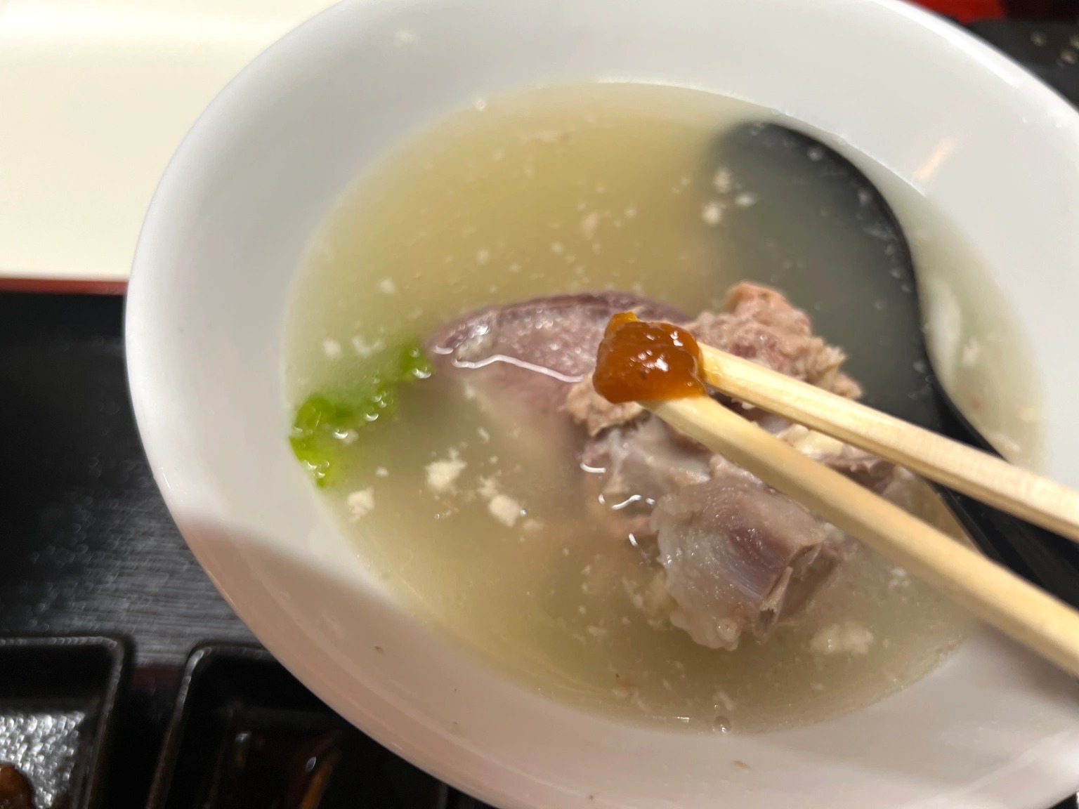 We try honejiru (bone soup), a delicious Okinawan specialty hard to
