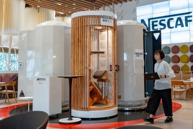 We take a giraffe nap in a standing sleep pod at a cafe in Tokyo